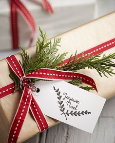 a gift wrapped in brown paper with a red ribbon