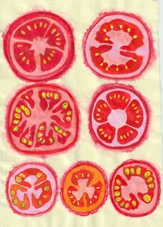 four slices of tomato on a piece of white paper with red and yellow paint splatters