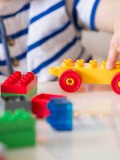 a child is playing with legos on the table