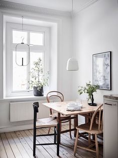 an instagram page with a wooden table and chairs in the center, on top of a wood floor next to a window