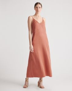 All of the elegance, none of the effort. Our vintage wash maxi slip dress is super soft to the touch and made with Lyocell, a biodegradable fabric made from the cellulose found in wood pulp. Not only does it require less water to produce, it’s wrinkle-, shrink- and static-resistant. With an easy drape and relaxed fit, it’s a flattering pick for date night or a weekend afternoon. Just add a few accessories and go  | Quince | Women's Vintage Wash Tencel Maxi Slip Dress in Terracotta, Tencel Woven, Silk Pajama Pants, Staple Dress, Halter Midi Dress, Maxi Slip Dress, Quince Dresses, Maxi Tank Dress, Linen Clothes, Natural Fabrics, Stunning Dresses