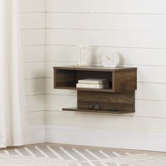 a shelf that has some books on it and a clock sitting on top of it