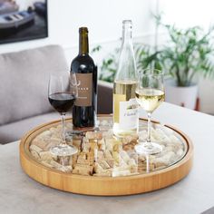 wine glasses and corks are on a tray