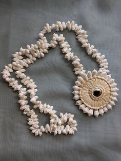 Vintage beach jewelry shell Operculum costume jewelry necklace for the summer.  Good vintage condition. Beach Shell Necklace Made Of Mother Of Pearl, White Shell-shaped Shell Necklace, Traditional Adjustable Shell Necklace, Shell Pendant Necklace For Vacation, Unique Shell-shaped Shell Necklaces, Traditional Shell-shaped Beach Jewelry, Shell-shaped Mother Of Pearl Necklace For Beach, Beach Shell Necklace In Mother Of Pearl, Beach Shell Necklaces In Mother Of Pearl