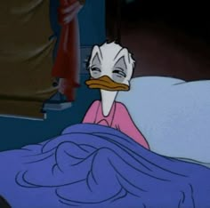 a cartoon duck is laying in bed with blue sheets