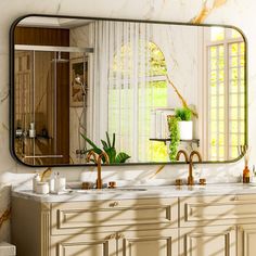 a bathroom with marble counter tops and gold faucets on the sinks, in front of a large mirror