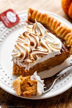 a slice of pumpkin pie with whipped cream on top