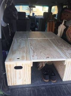 the back end of a van with a wooden table in it