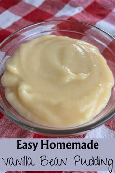 homemade vanilla bean pudding in a glass bowl on a red and white checkered tablecloth