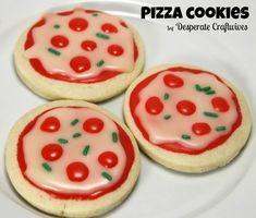 three decorated cookies sitting on top of a white plate