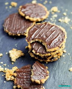 chocolate covered cookies on top of each other with one broken in half and the rest partially eaten