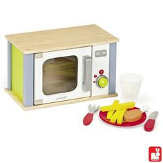 a toy microwave oven with hotdogs and french fries on the plate next to it