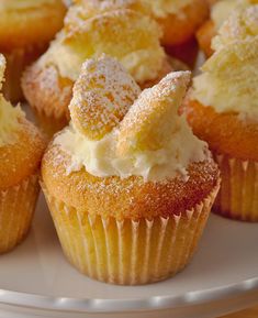 several cupcakes with powdered sugar on them are sitting on a white plate