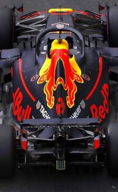 the red bull racing car is driving down the track