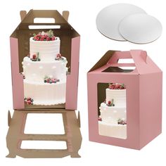 a cake in a pink box with two plates next to it