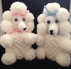 two white poodles with pink bows on their heads and eyes are standing next to each other