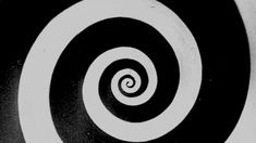 a black and white photo with a spiral design in the center, taken from above