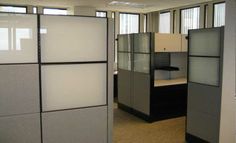 an office cubicle with glass partitions in the middle