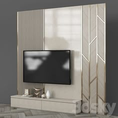 a tv is mounted on the wall in front of a white cabinet with gold trim