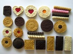 there are many different cookies and pastries on the table together, including one with a heart