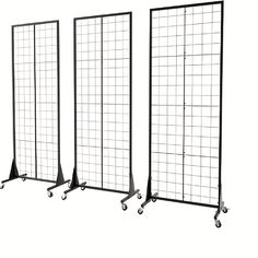 three black metal partitions with wheels and grids on the sides, each side is shown