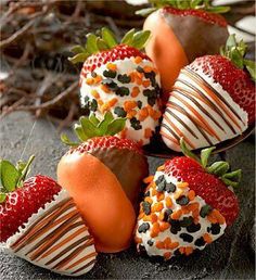 several chocolate covered strawberries are arranged on the ground