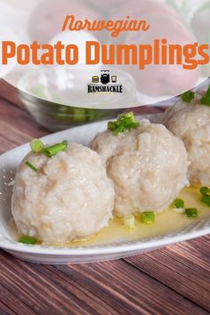 three dumplings on a white plate with green onions