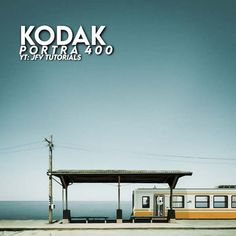 the train is parked at the station next to the water and under the sign that says kodak portraits