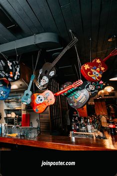 guitars hanging from the ceiling in a restaurant