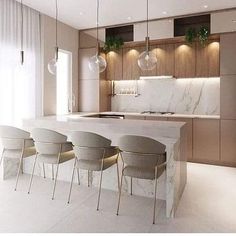 a kitchen with marble counter tops and chairs