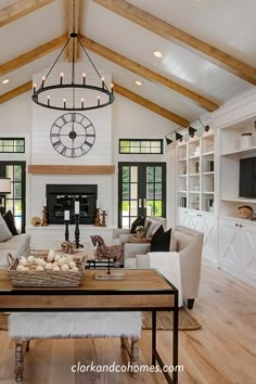 a living room filled with furniture and a large clock mounted to the wall above it