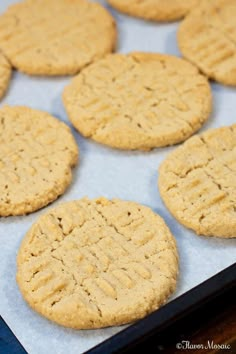 several cookies are on a baking sheet ready to be baked in the oven for consumption