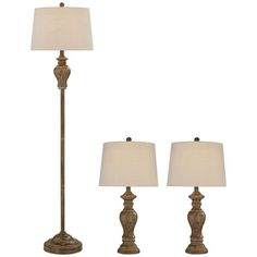 three lamps with white shades on them and one lamp is turned off to the side