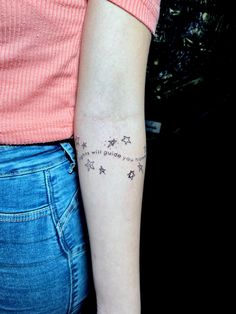 a woman with a star tattoo on her arm