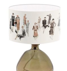 a lamp that has some pictures on the lampshade and it's shade