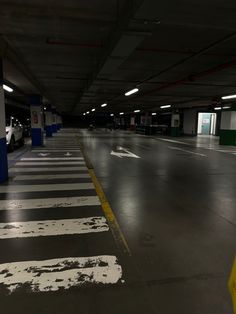 an empty parking garage filled with lots of white and black paint on the floor,