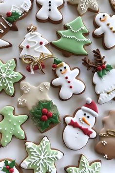 many decorated christmas cookies on a white surface