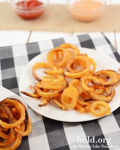 some onion rings are on a white plate