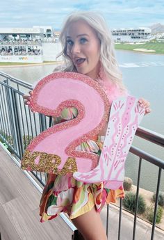 a woman holding up a sign that says 2