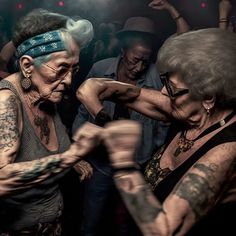 two older women are dancing together in the dark with their arms wrapped around each other