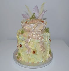 a yellow cake decorated with flowers and leaves