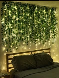 a bed sitting under a green wall covered in lights