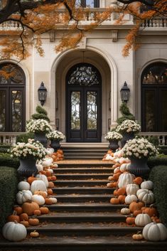 the front steps are decorated with pumpkins and gourds