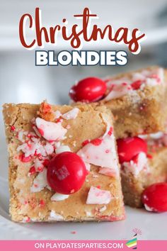 christmas blondies with cherries and white chocolate on the top, in front of a plate