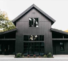 a large black house with lots of windows