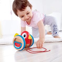 "Buy the Hape Baby Bird Pull-Along Wooden Toddler Toy at Michaels. com. Baby bird can't fly yet, but she loves to stand on her own and take small steps forward! Use the cord to pull her and she wobbles and flaps her wings. Baby bird can't fly yet, but she loves to stand on her own and take small steps forward! Use the cord to pull her and she wobbles and flaps her wings. The bright, attractive colors appeal to children and the non-slip surface on the wheel rims keep the toy steady on smooth floo Hape Toys, Pull Along Toys, Wooden Toys For Toddlers, Hapkido, Small Steps, Baby Bird, Gross Motor Skills, Activity Toys, Pull Toy