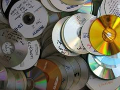 many cds are stacked up together on top of each other