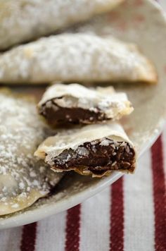 chocolate filled pastries on a plate with a red and white striped table cloth in the background