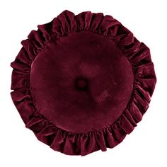 a round pillow with ruffles on the top and bottom, in maroon velvet