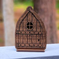 a wooden cutout of a house with a window